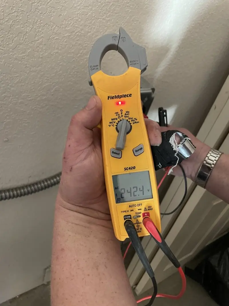 Voltage testing with clamp meter during Recessed Lighting Installation in Chesterland